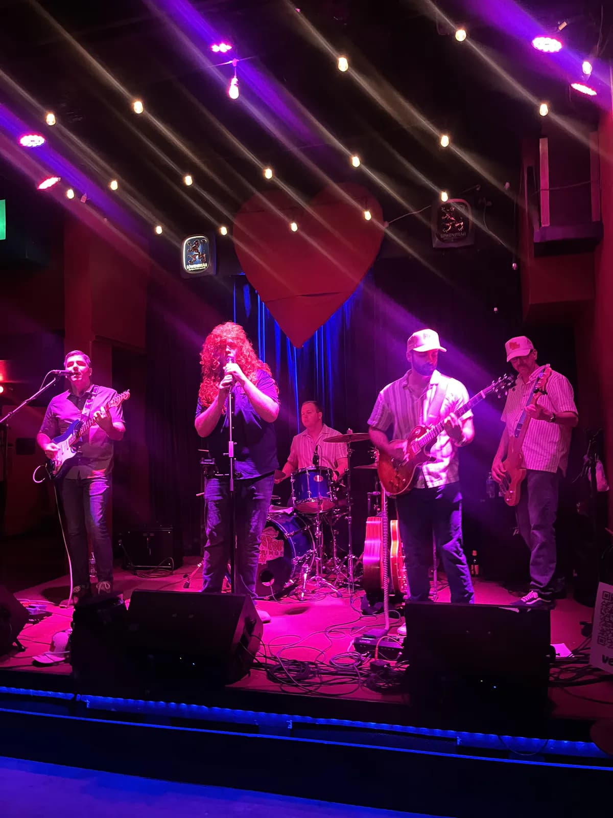 The Pipe Dream performing under purple lights at Big Top Lounge